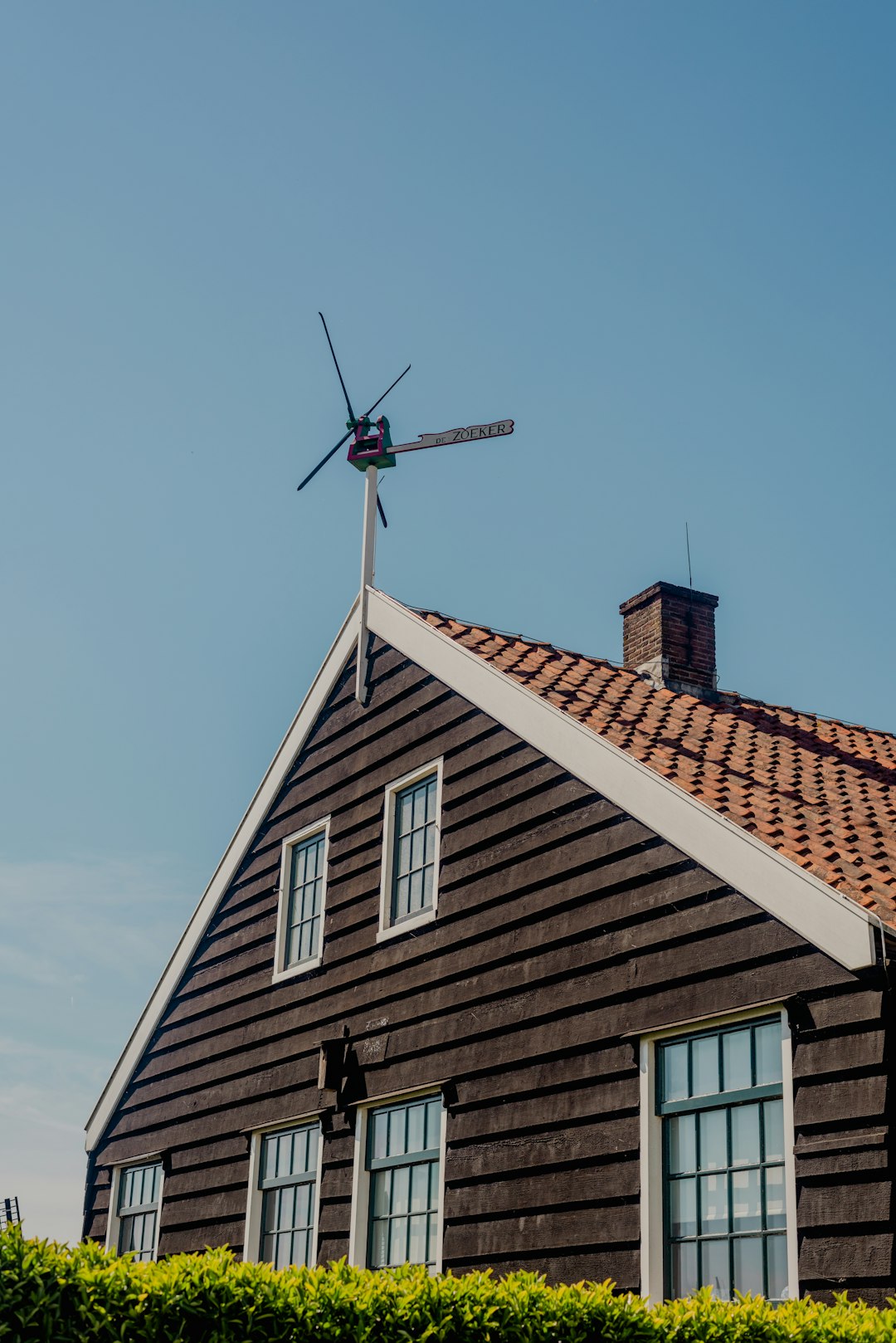 about-us-img a-house-with-a-windmill-on-top-of-it-kseuc-ubsuo