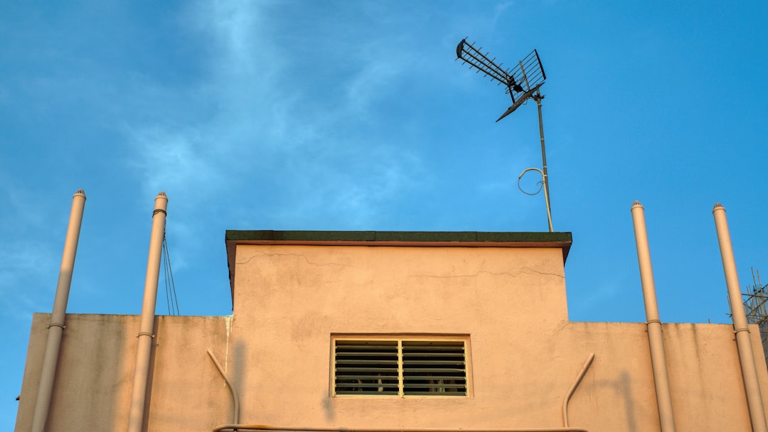 a-tall-building-with-a-weather-vane-on-top-of-it-e8g1qnrfw44